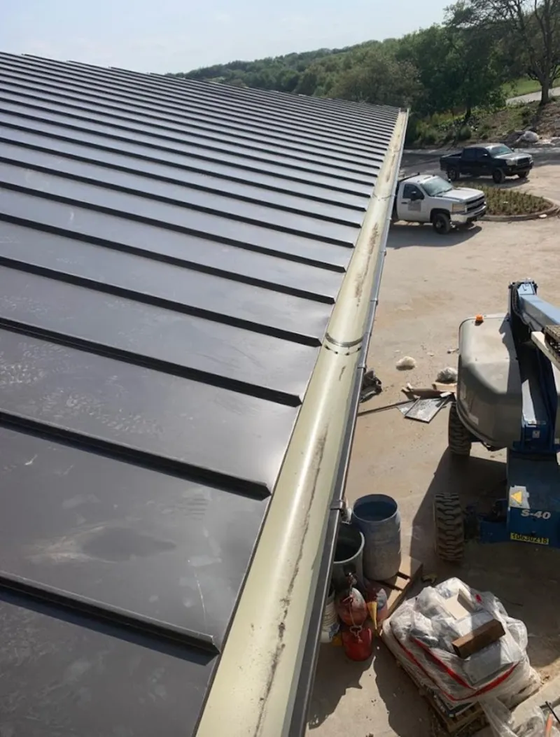 Standing seam panel and gutter detail on a metal roofing jobsite in Sunbury